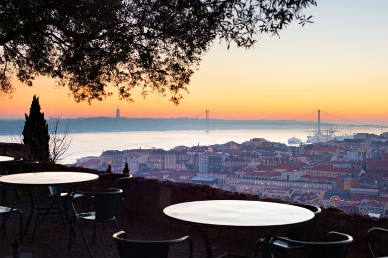 Outdoor restaurant with fantastic view of Lisbon at sunset. Portugal